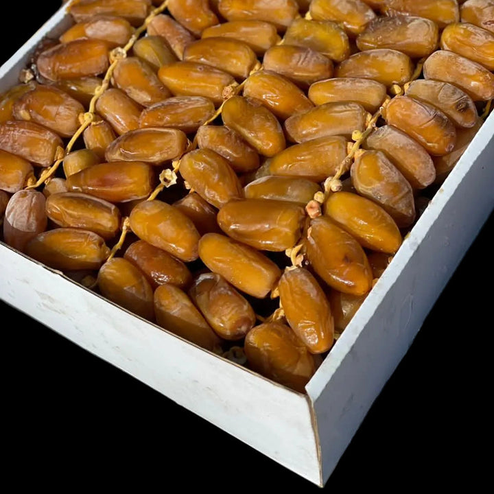 Box of dates with a green label on a black background